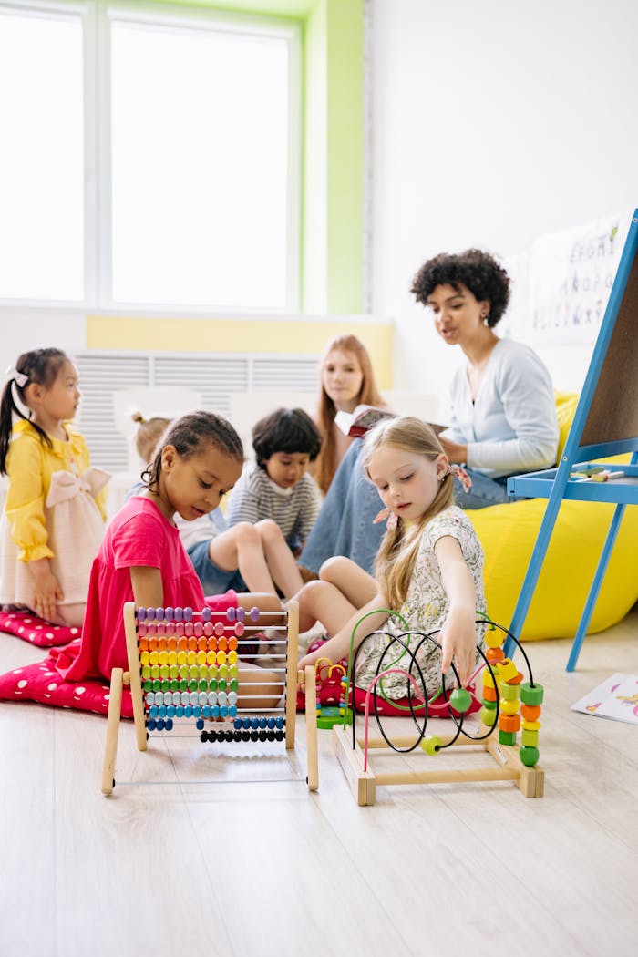 Preschool children with a teacher engaging in educational activities in a bright classroom.